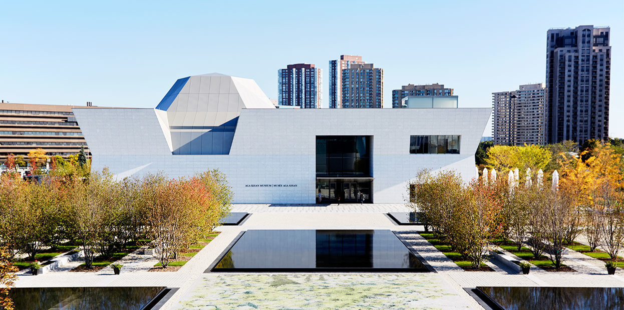 The white-Brazilian granite west-facing facade of the Aga Khan Museum in daytime.